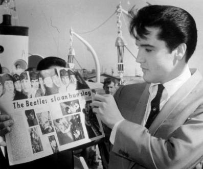 Elvis looking at Beatles magazine